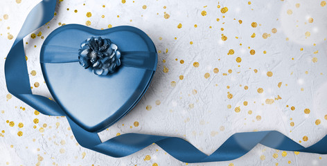 Valentines day, Mothers day greeting mock up banner. Blue heart gift box with curl ribbon on white background. Bokeh lights. Golden confetti. 