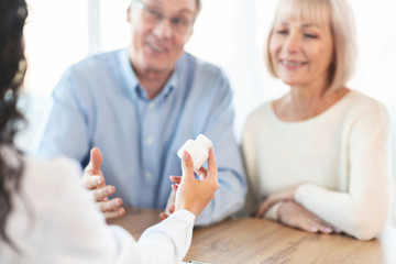 Doctor giving some pills to elderly couple