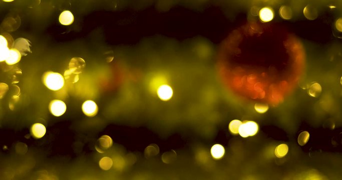 Defocused lights of the moving Christmas tree. Christmas background decoration