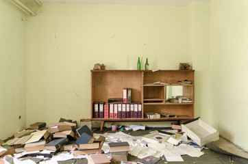 Still life of cabinet with clutter of bookkeeping around it in a former distillery.