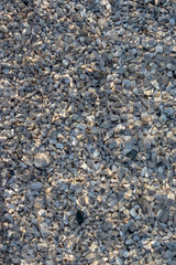 Crstal clear water of the adriatic sea, beach shot. Small white and blue waves on a rocky pebble beach. Shot from above, texture of stones