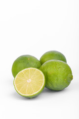 Fresh lime, half and quarter part on white background. Green citrus fruit. 
