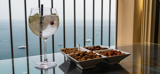 Large cocktail drink glass and snack of nuts