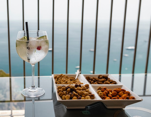 Cocktail and snacks in front of tropical sea