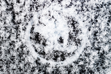 Logo of well-known brand of cars under fluffy snow.
