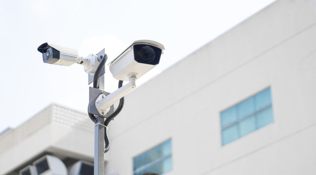 CCTV surveillance security camera video equipment on pole outdoor building safety system area control and copy space