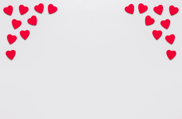 Stock photo of wooden red hearts on a white background with a space for text