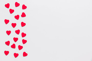 Stock photo of wooden red hearts on a white background with a space for text