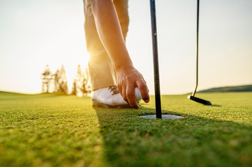 lifestyle, golf, activity, outdoor, sport, golfer concept. Golfers collect golf balls that hole in...