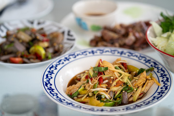 Spicy thai papaya salad on table.