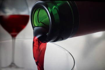 Pouring red wine in a glass 