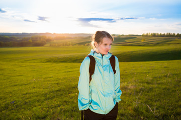 Young woman with backpack hiking in the mountains