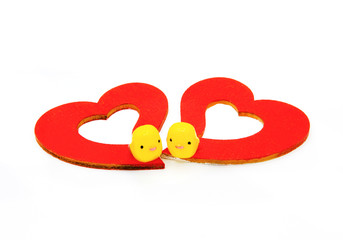 Two yellow duck toys and red heart isolated on white background. Valentine day and Couple lovely concept. Selected focus at duck. 