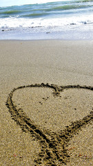 heart drawn on the sandy seashore