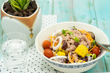 Bowl of mixed vegetables in tuna salad. 