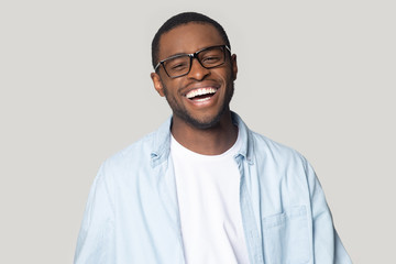 African man with white smile pose isolated on gray background