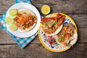 Mexican tacos on wooden background