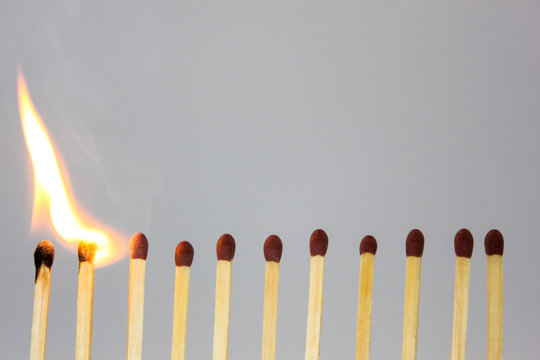 line of matches igniting in a chain reaction