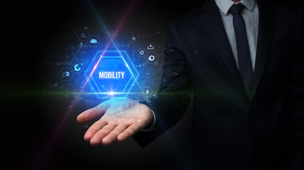 Obraz premium Man hand holding MOBILITY inscription, social media concept