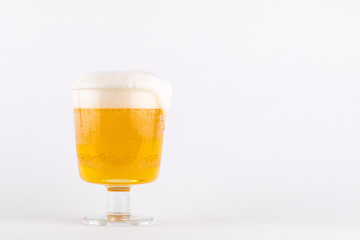 Beer in glass, foam dripping, isolated on white background, copy space