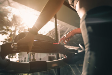 Obraz premium fitness, workout, gym exercise, lifestyle and healthy concept. Close-up The hands and arms of women exercising on the treadmill in the gym for good health and strength at sunset..