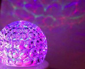 Disco ball with pink and purple reflections