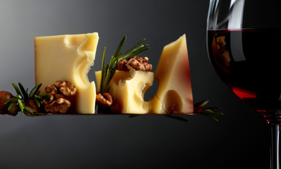 Naklejka na ściany i meble Maasdam cheese with walnuts, rosemary and red wine.