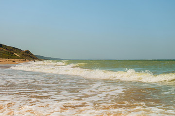 Sea waves falls on sandy shore. Tidal water surf. Seascape. Azov sea, Temryuk Bay, Peresyp.