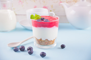 Bowl of breakfast healthy muesli with blueberry, strawberry and yogurt.