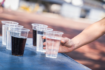 Hand is catching a glass of water.