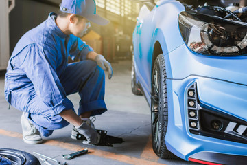 Asian man car inspection Measure quantity Inflated Rubber tires car.Closeup hand holding tire and...