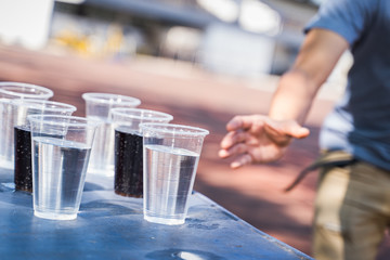 Hand is catching a glass of water.