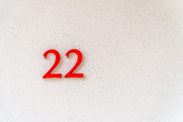 White textured background with bright red number 22 off center