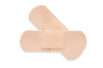 Top view of two beige adhesive bandages isolated on white