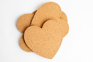 Pile with many hearts made from light brown textured cardboard, isolated on white with space for text