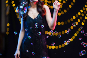 beautiful girl playing with soap bubbles.