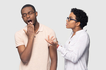 African wife nags husband express discontent while he yawning
