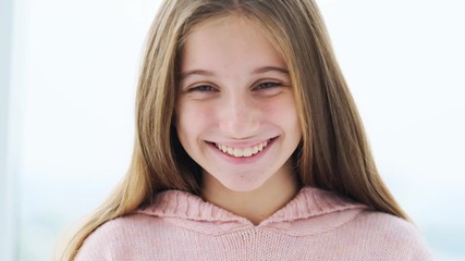 Cute long haired girl expressing happiness with wide smile