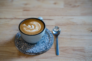 Cup cappuccino on wooden table.