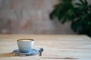 Cup coffee on textured wooden table.
