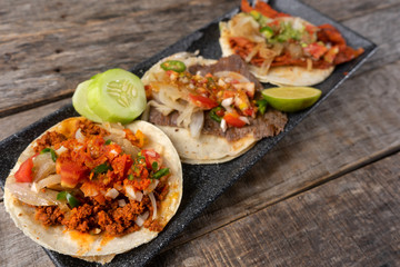 Mexican tacos on wooden background