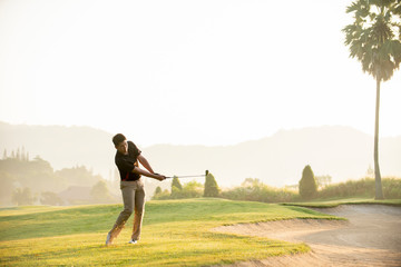 Asian man golfer playing golf at golf course - obrazy, fototapety, plakaty