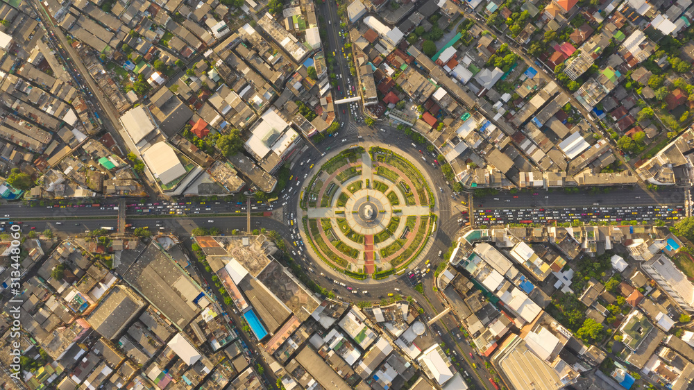 Wall mural Road roundabout with car lots Wongwian Yai in Bangkok,Thailand. street large beautiful downtown at evening light.  Aerial view , Top view ,cityscape ,Rush hour traffic jam. - Wall murals