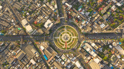 Road roundabout with car lots Wongwian Yai in Bangkok,Thailand. street large beautiful downtown at evening light.  Aerial view , Top view ,cityscape ,Rush hour traffic jam.