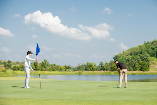 Two Asian Man Golfer Playing Golf At Golf Course