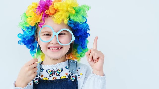 School girl in colorful wig raising pointing finger