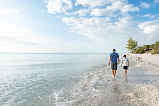Father and son walking on a beach