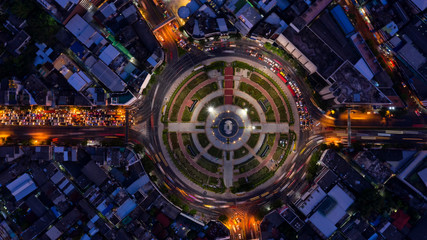 Road roundabout with car lots in Bangkok,Thailand. street large beautiful downtown at evening light.  Aerial view , Top view ,cityscape ,Rush hour traffic jam.