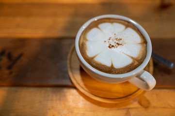 Close up of Cappuccino coffee cup on wooden table