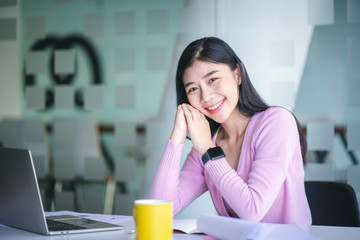 Confident happiness young woman working on laptop or notebook in her office. Beautiful Freelancer Woman working online at her home. Beauty Asian business woman concept.